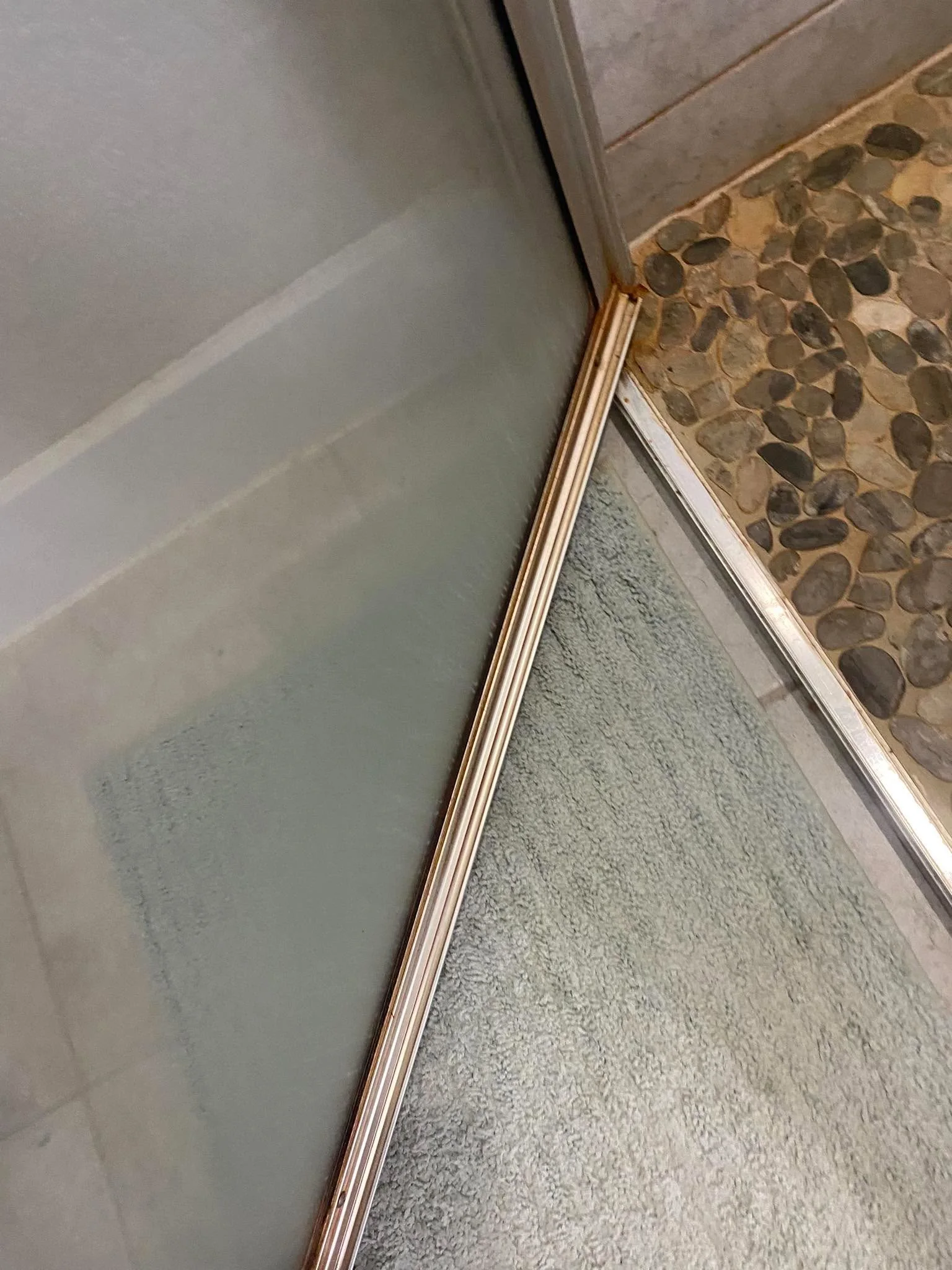 Shower door track before cleaning